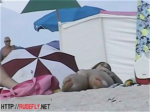 Beach bombshells hang out nude below the sun